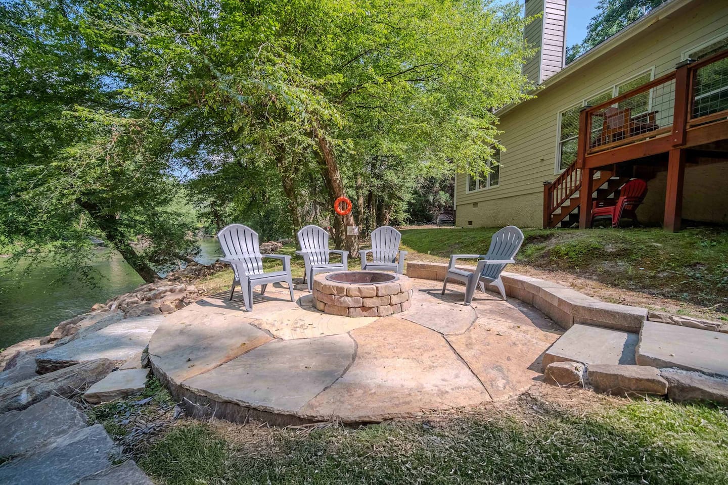 Unwind by the fire pit just steps from the river's edge. Surrounded by nature and outfitted with comfortable Adirondack seating, just a short walk up to the spacious back deck.