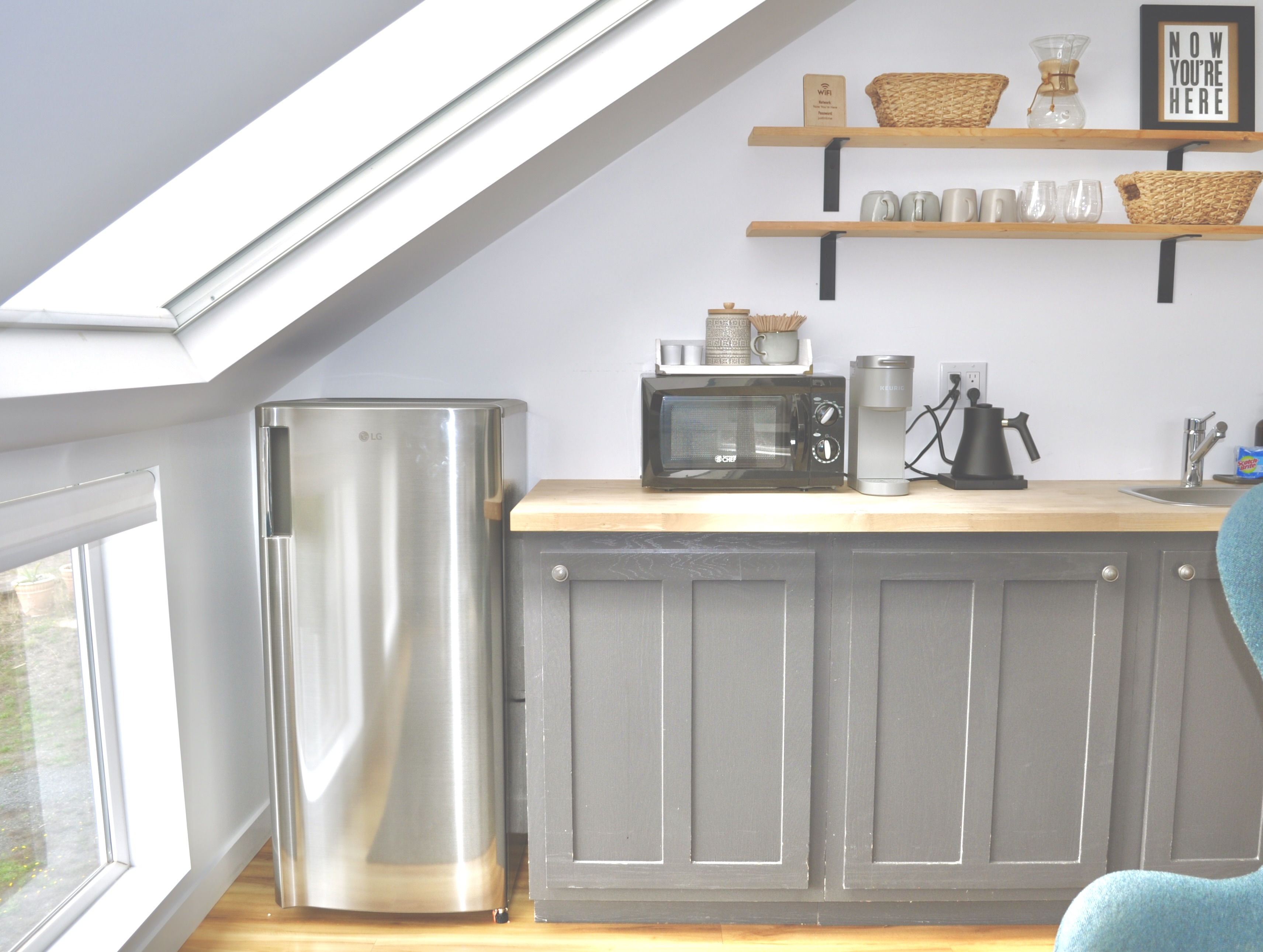 kitchenette with microwave and apartment-sized refrigerator/freezer.