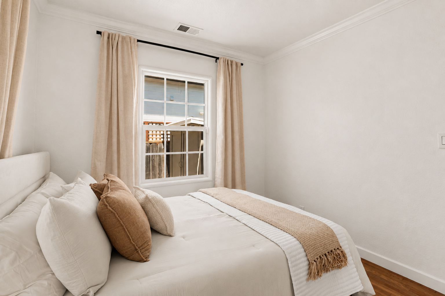 Bedroom 2 offers a cozy queen bed, soft bedding, natural light, and a peaceful atmosphere for a restful night’s sleep.