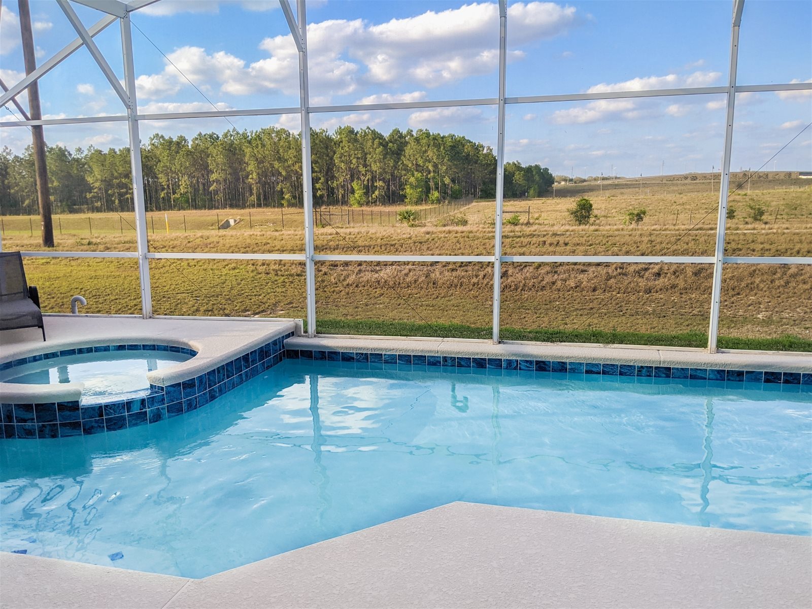 Lush nature right outside your Private Screened Patio Pool with connecting Hot Tub.