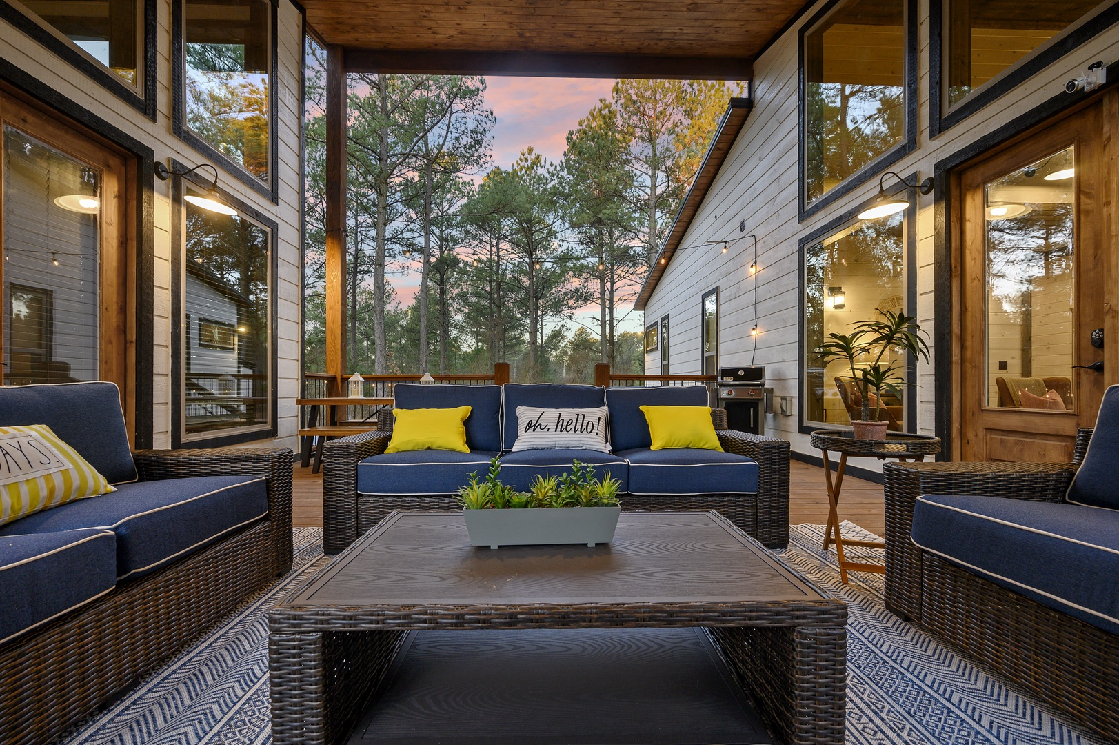 Lounge fireside, surrounded by forest views and warm cabin glow.