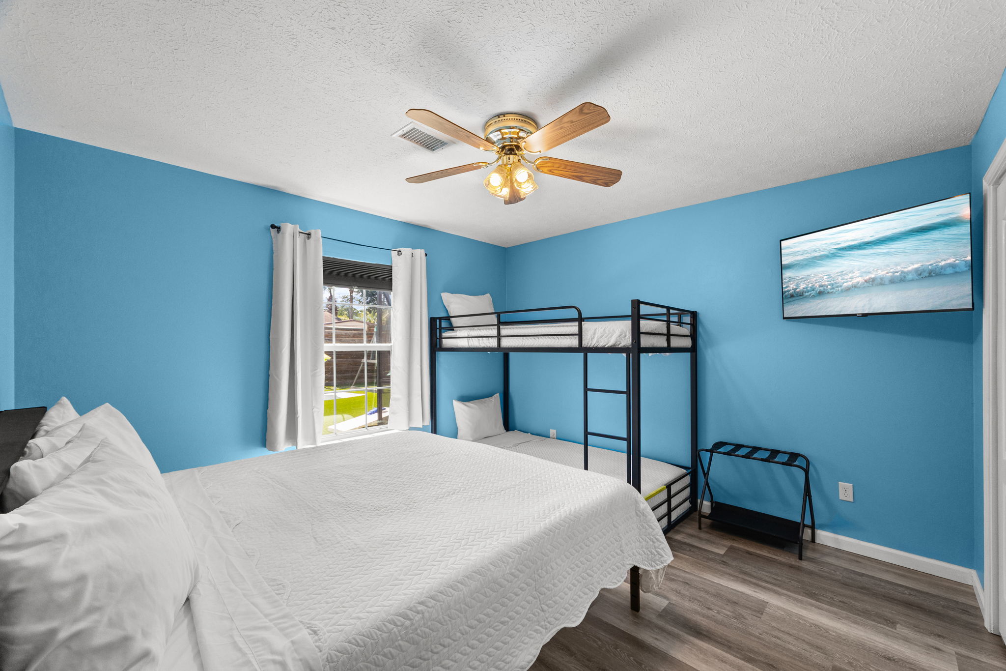 Welcome to the vibrant Blueberry Bliss Room! This fun, spacious room is perfect for families or groups, featuring an ultra-comfortable king bed and a set of sturdy XL twin bunk beds. Enjoy your favorite shows on the 43-inch smart TV, unpack easily with two