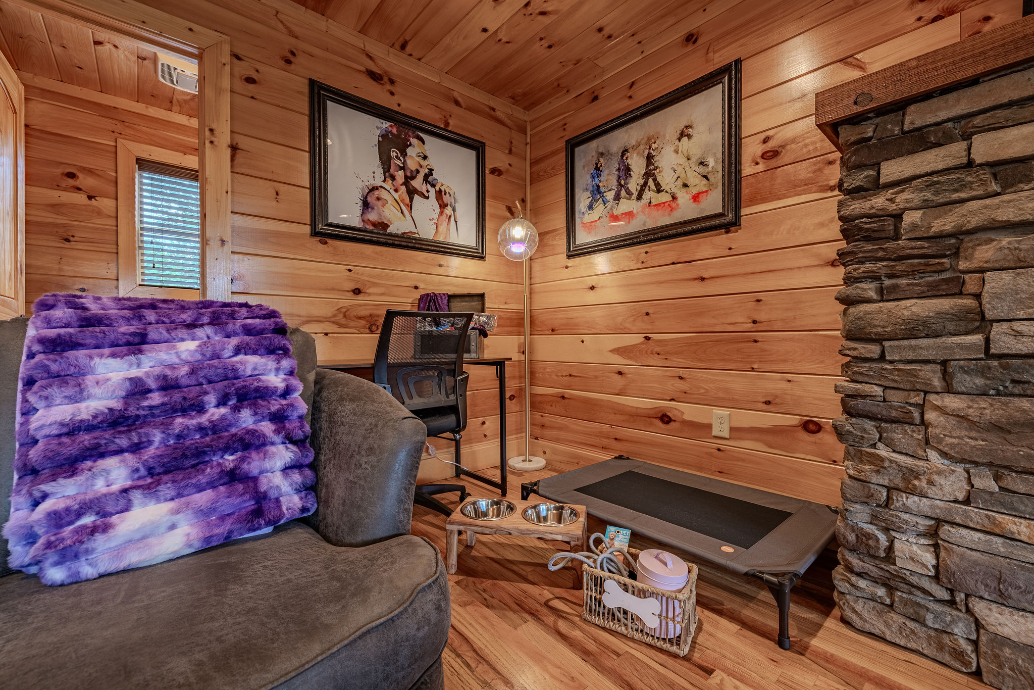 The Grand Lounge is the heart of Headliner Hideaway, with warm wood, comfortable seating, a fireplace, and space for the whole group to gather.