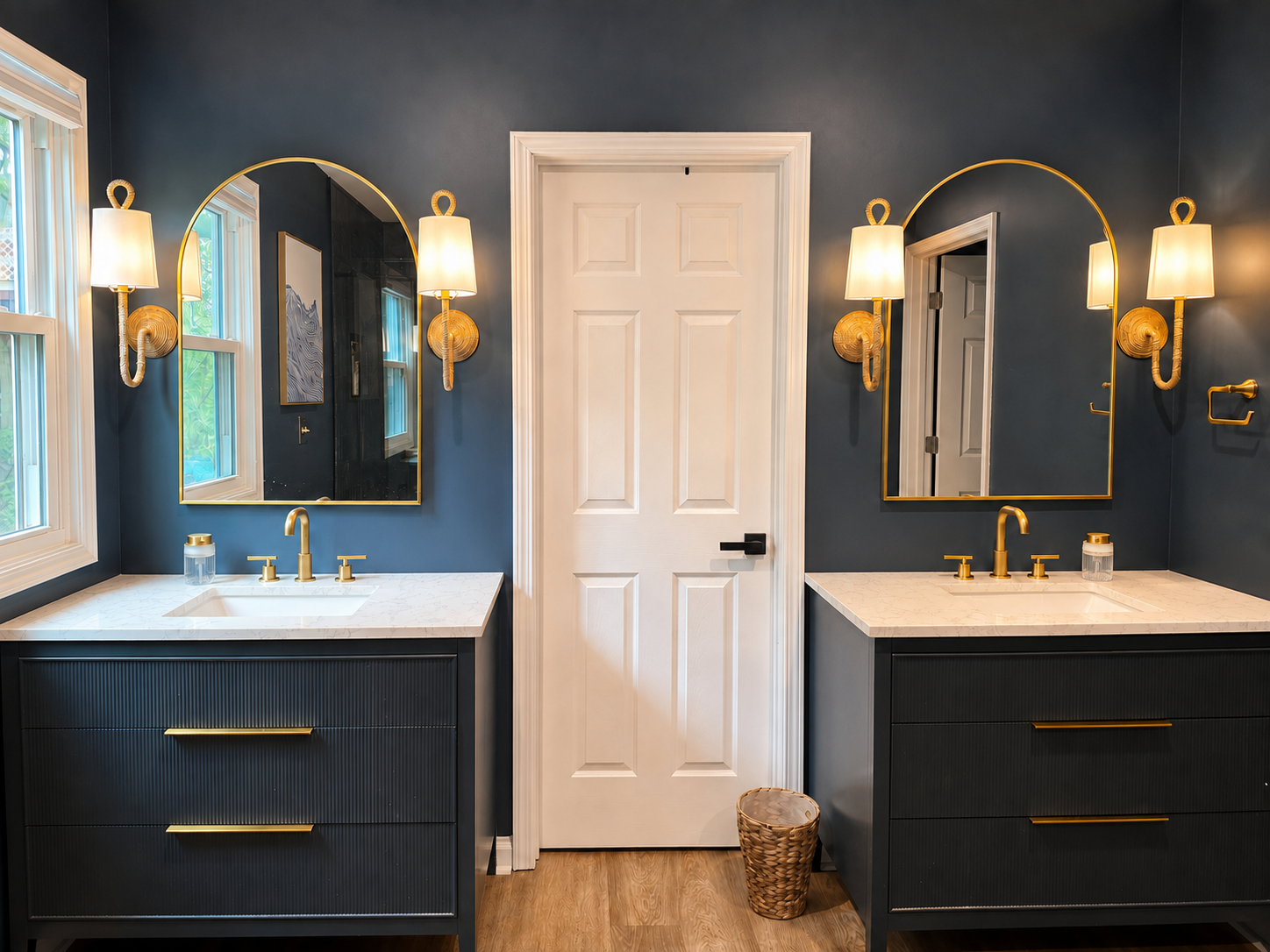 Spacious primary bathroom with dual vanities, warm lighting and plenty of room to get ready.