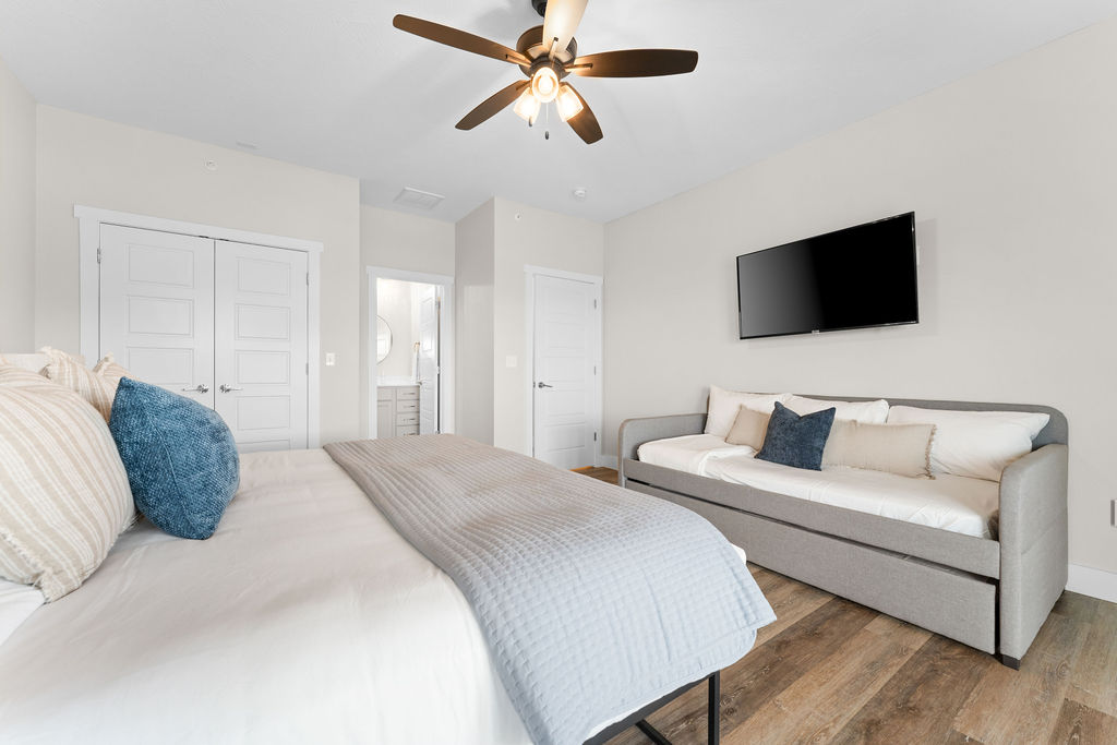 Upper level King bedroom w/ ensuite bath, daybed with trundle, and deck access