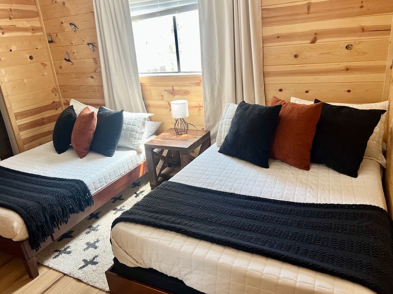 Three of 5 bedrooms pictured, featuring two full-sized beds (sleeps up to 4 people). This room has a Roku streaming TV.
