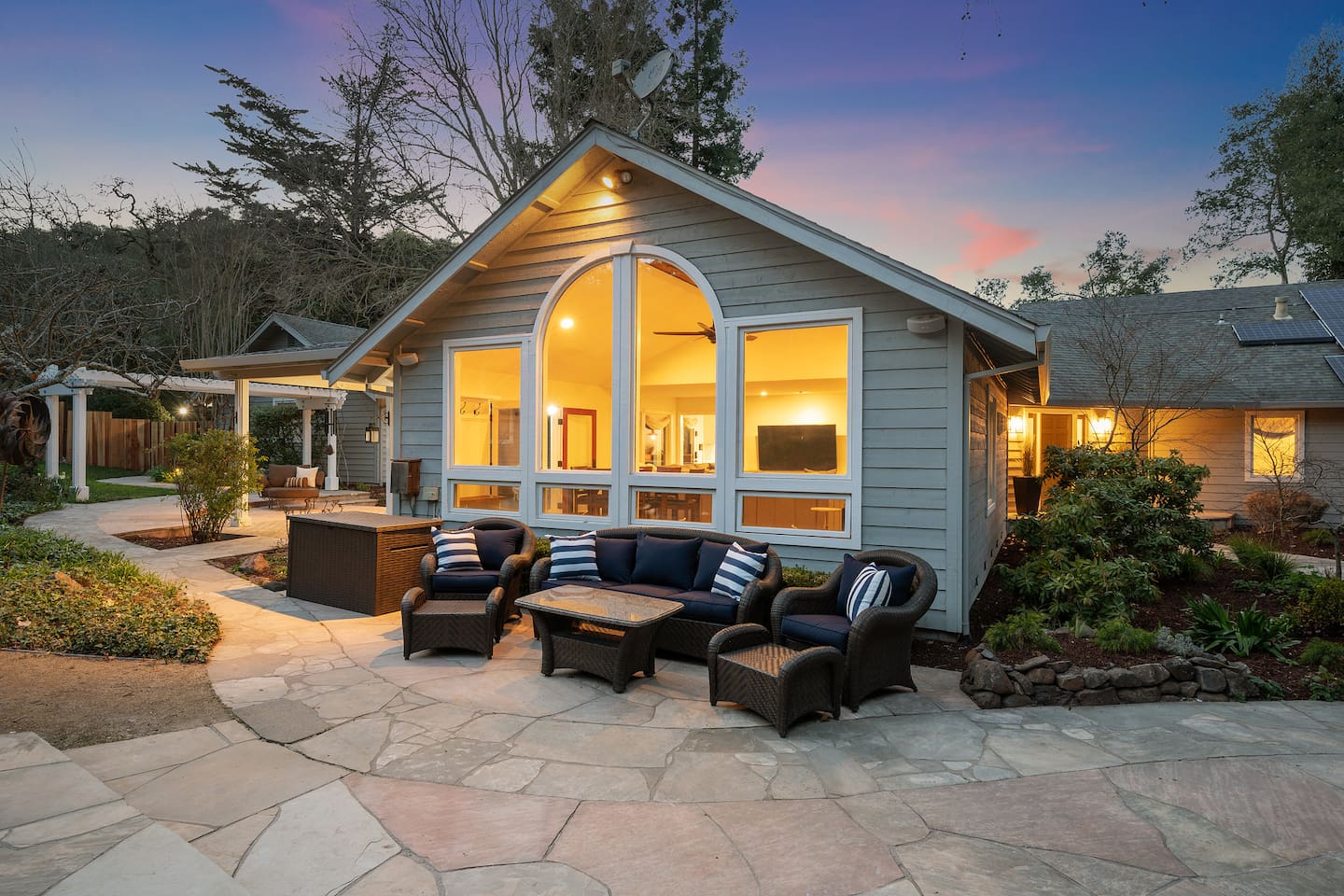 There are 5 separate seating areas around the property. Just outside the living room, this comfy couch and set of 2 lounge chairs overlooks the pool.
