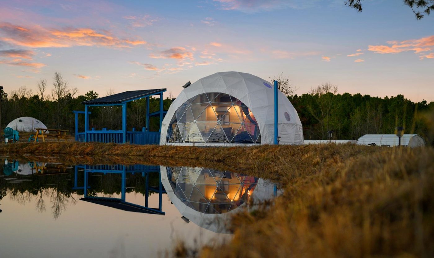 The Incredi-Dome reflected in its private pond at sunset