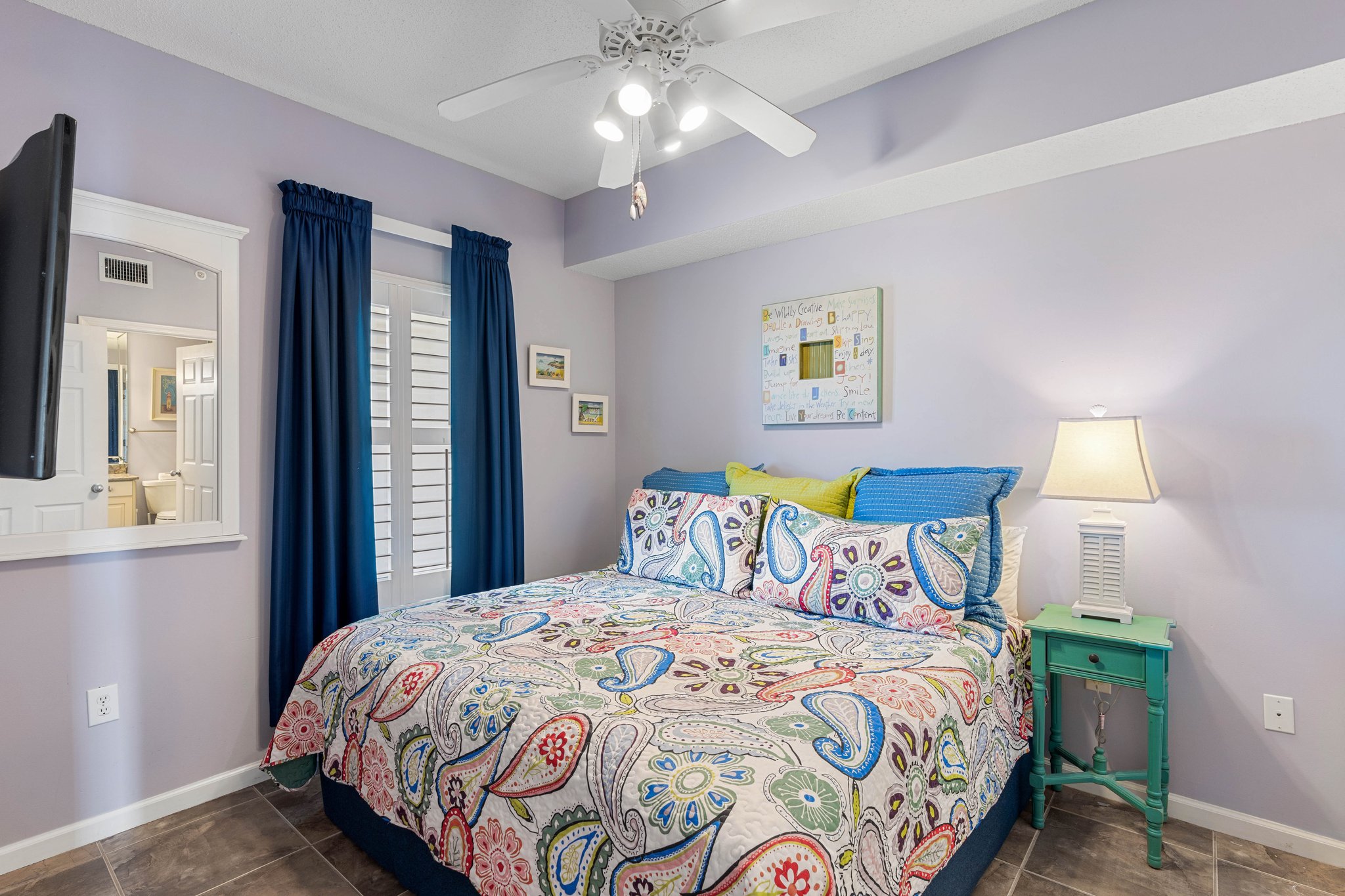 Guest bedroom w/ two beds, cheerful colors & a fun coastal vibe.