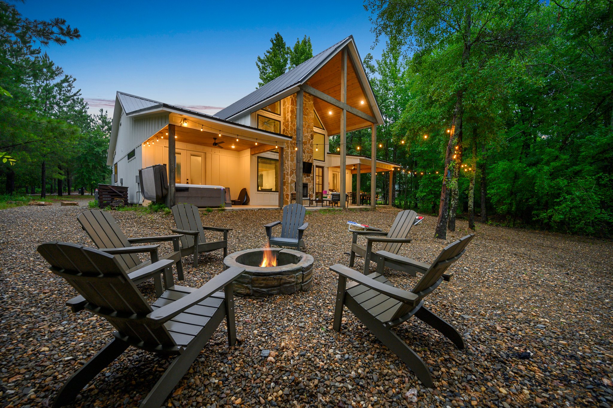 Unwind around the fire pit with friends or family under the glow of ambient lighting in this tranquil Creekside setting