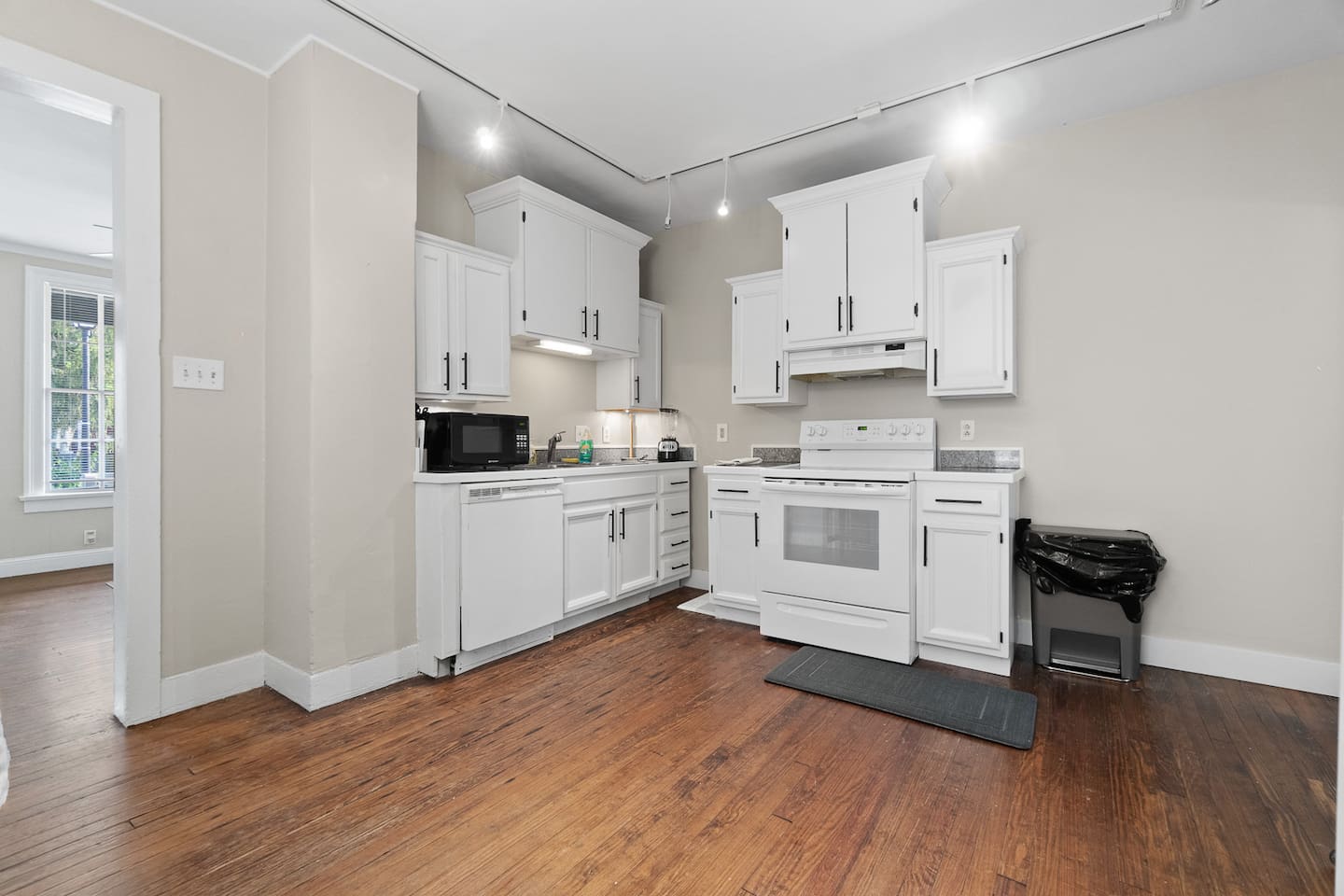 Elegant, modern kitchen with all-white interiors, featuring sleek countertops, contemporary appliances, and a minimalist design that creates a bright and airy cooking space.