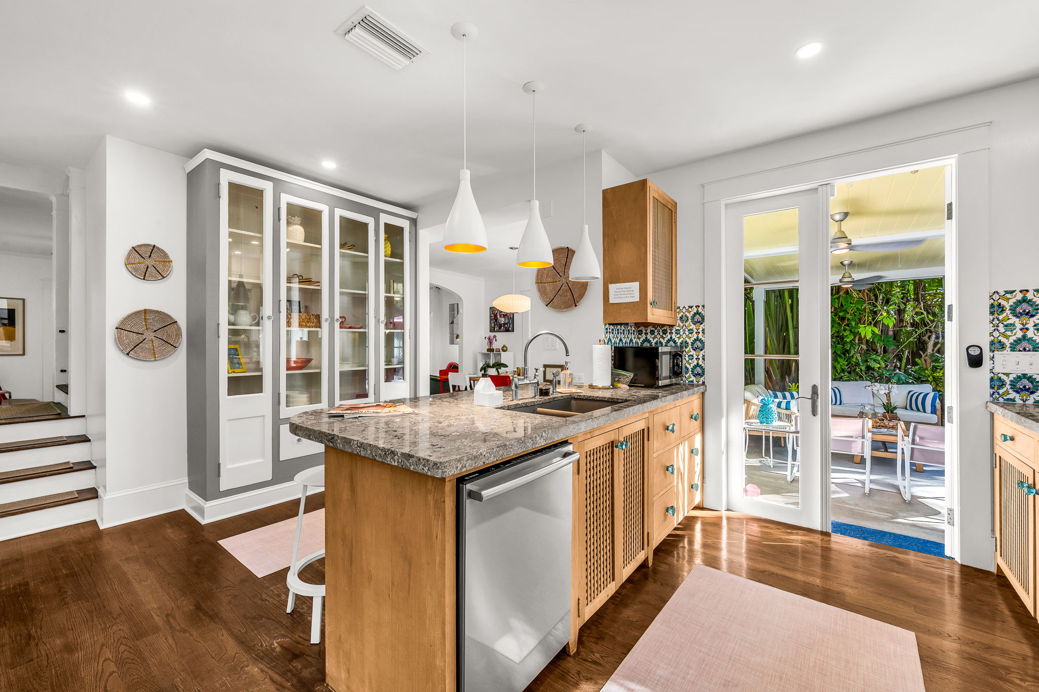 This fully equipped kitchen features a gas range stove, Nespresso, Keurig, and drip coffee makers, plus a blender and serviceware for 10. French doors lead directly to the patio with an outdoor dining table for 6—perfect for al fresco meals in paradise.
