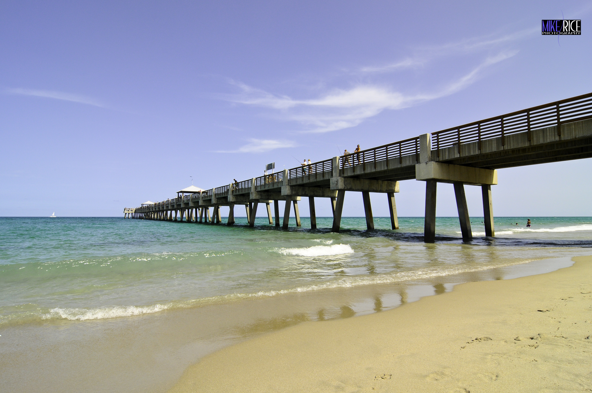 The iconic Juno Beach Pier stretches gracefully over crystal-clear turquoise waters, inviting visitors to stroll above the waves, watch the sunrise, or cast a line - an unforgettable spot capturing the natural beauty of Florida's Atlantic East Coast.