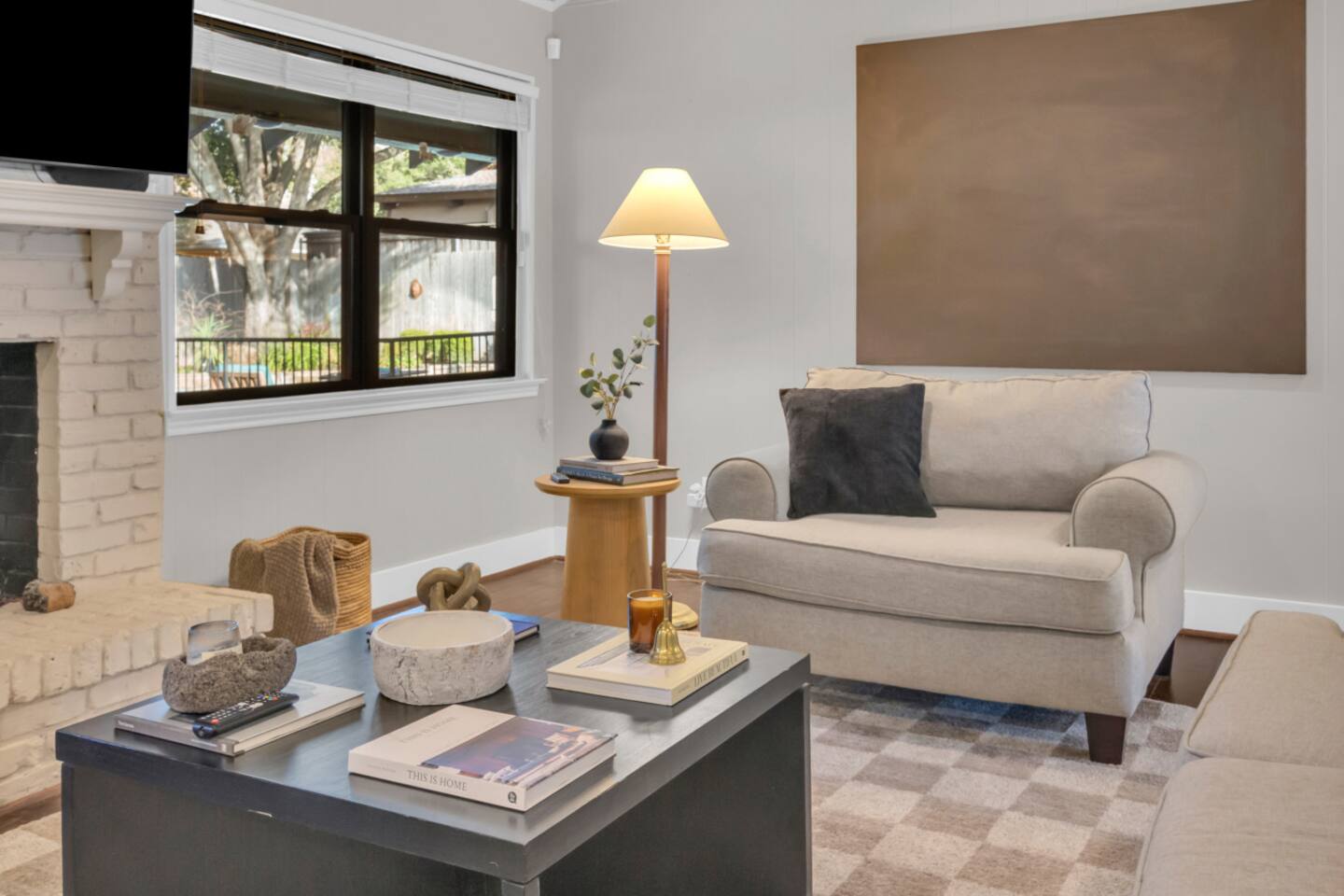 Elegant living room sitting area accented with curated artwork, offering a stylish and inviting space to relax.