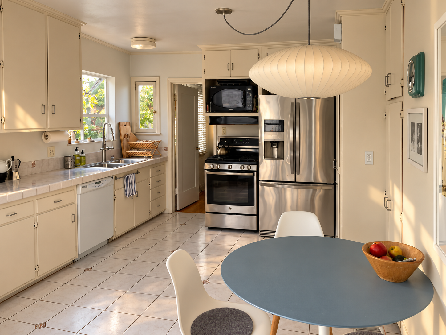 Kitchen with breakfast table and stainless steel appliances.
