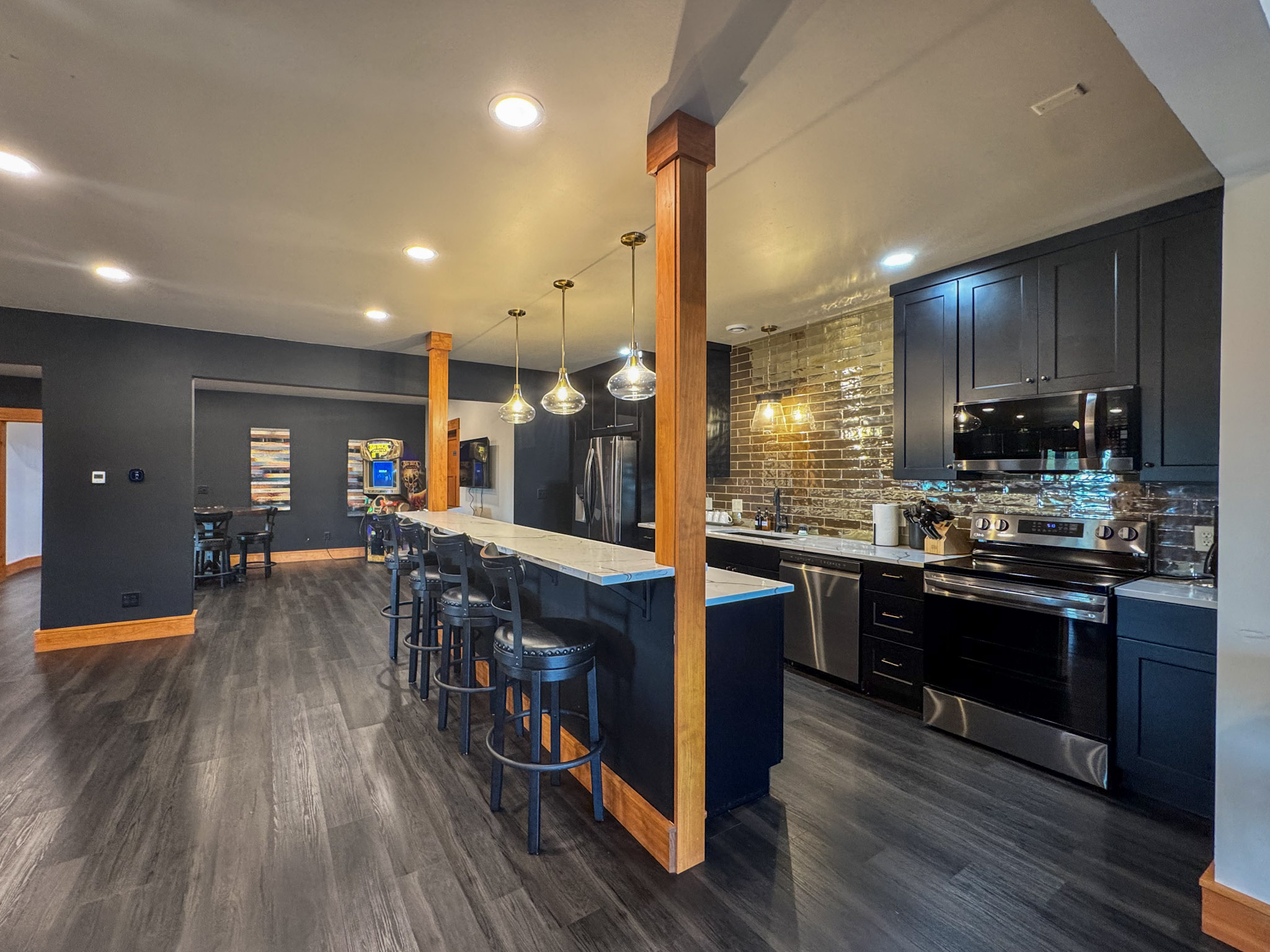 Downstairs kitchen with full-size appliances and bar seating.