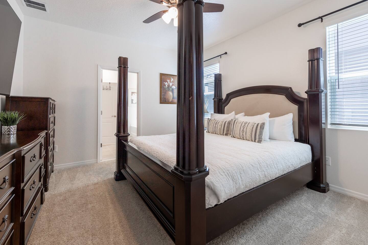 Downstairs Master Bedroom with California King Poster Bed with automatic bed incline and private bathroom and shower. Includes a 70 inch TV.  Luggage rack & laundry basket in closet.