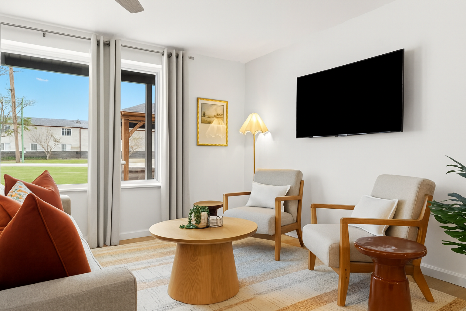 Cozy reading corner beside a mounted Smart TV—great for winding down after a day out.