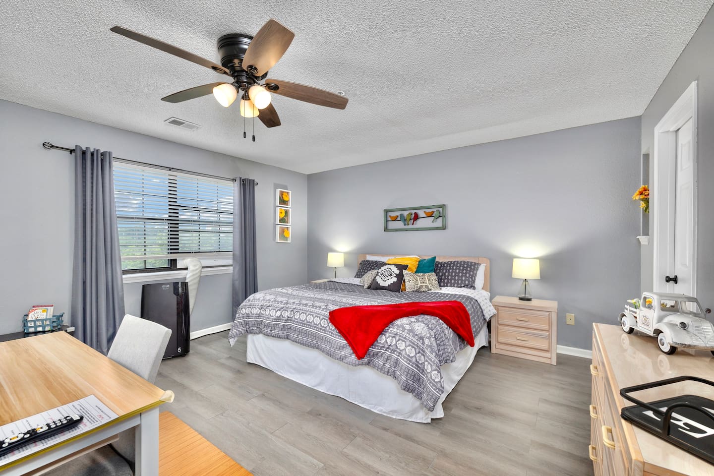 Master Bedroom: Bright room featuring vibrant decor, a comfy bed, and a lovely view!