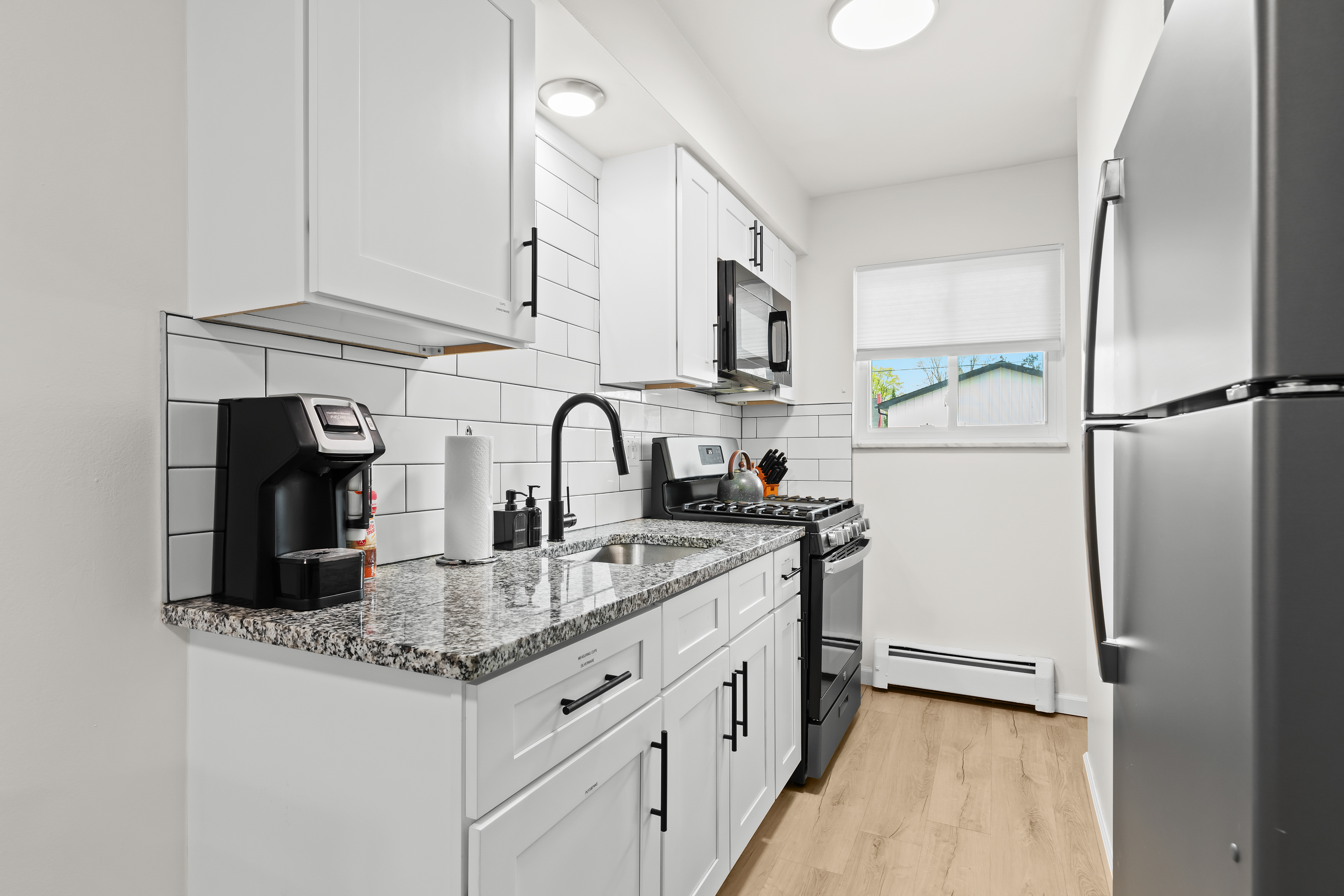 Whip up your favorite meals in a sleek, fully stocked kitchen—complete with granite countertops and a coffee station.