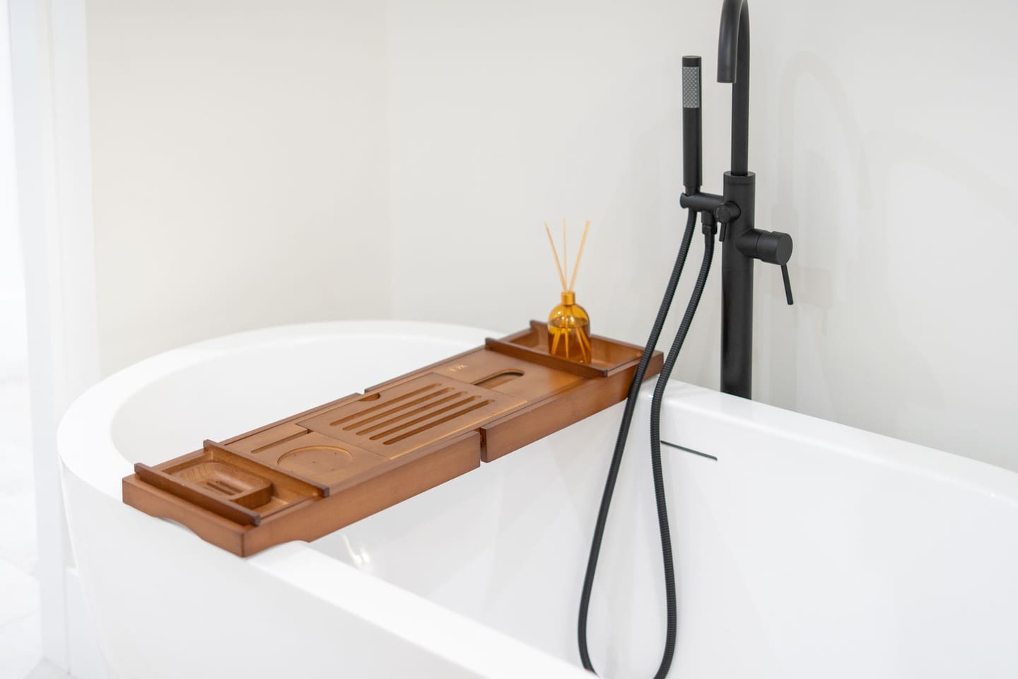 Sleek tub detail with black fixtures and modern design accents.