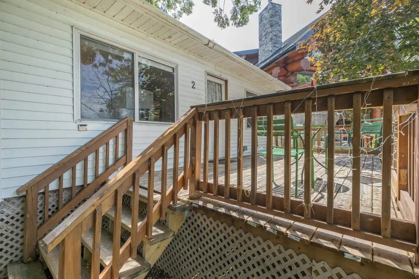 Cottage #2 exterior entrance with wooden steps and railing