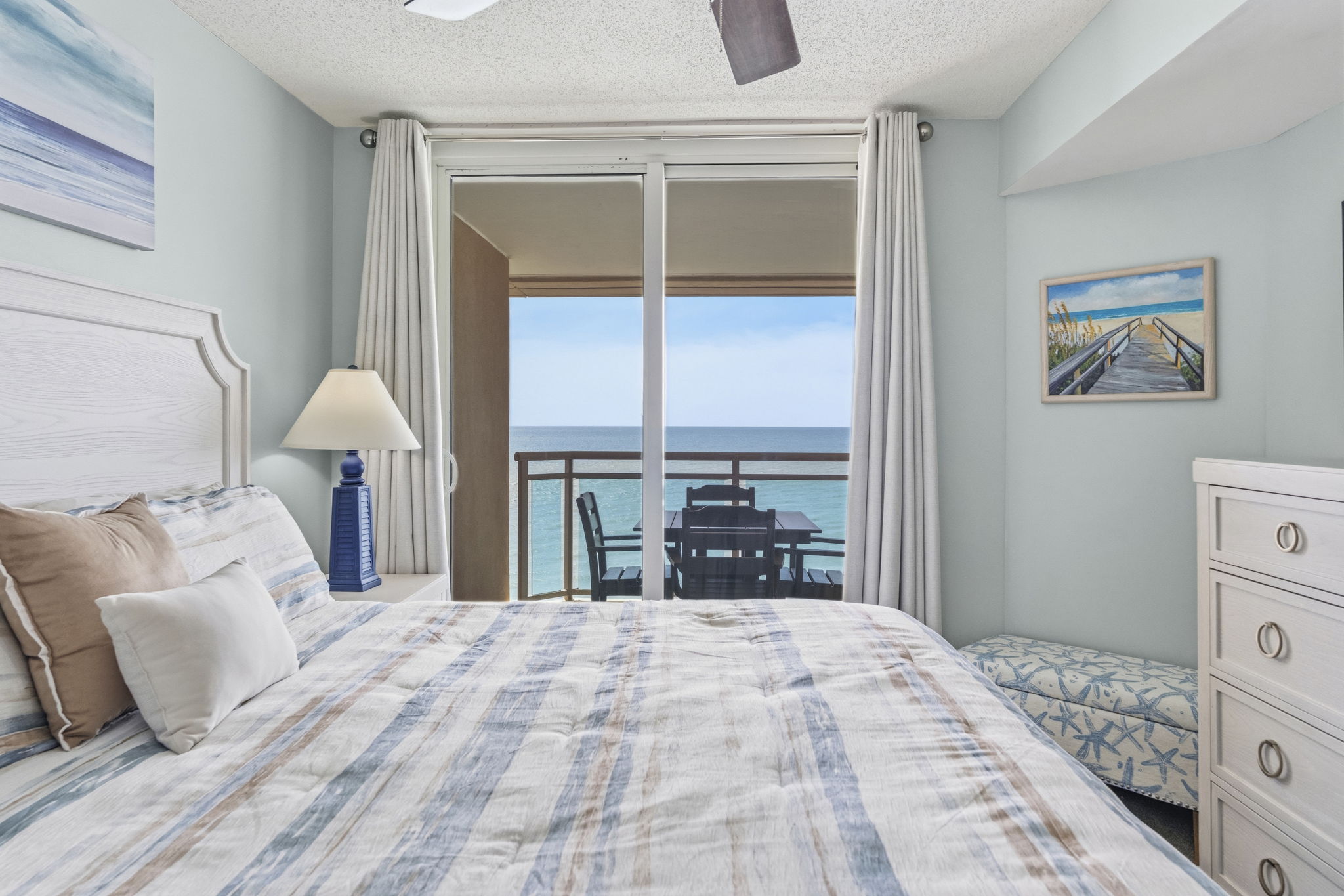 Primary Bedroom with King Bed, ensuite bathroom, and balcony with direct oceanview