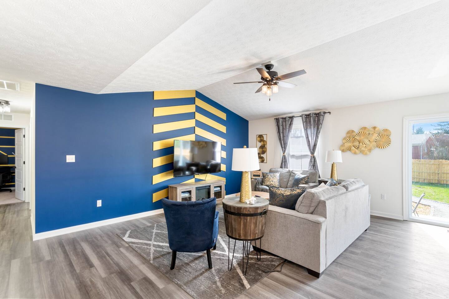 spacious living area with queen sized couch bed, tv, and electric fireplace heater