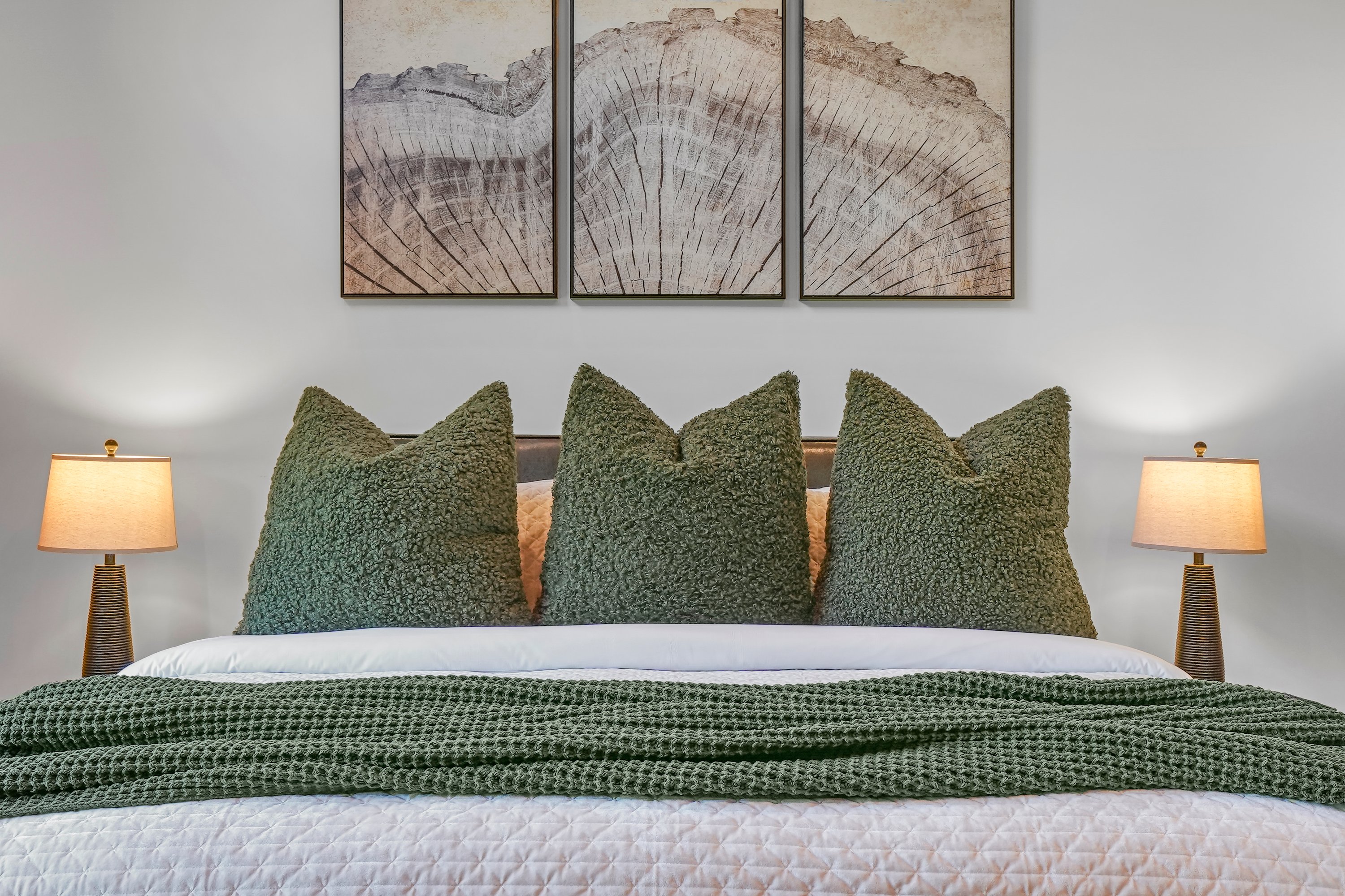 King Suite with vaulted ceilings an x-large TV. Unwind in the en-suite bathroom featuring a luxurious walk-in shower with a natural river rock floor, bringing  the Smoky Mountains indoors for a spa retreat.