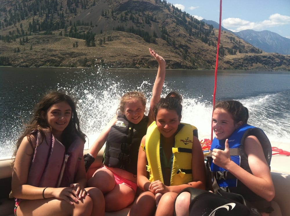 Kids smiling on a boat ride across Palmer Lake