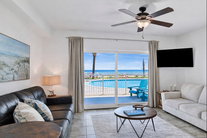 Living room with sleeper sofa, a 2nd sofa, smart TV, ceiling fan and balcony access