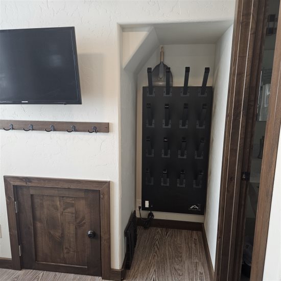 Boot drying machine next to bathroom.
