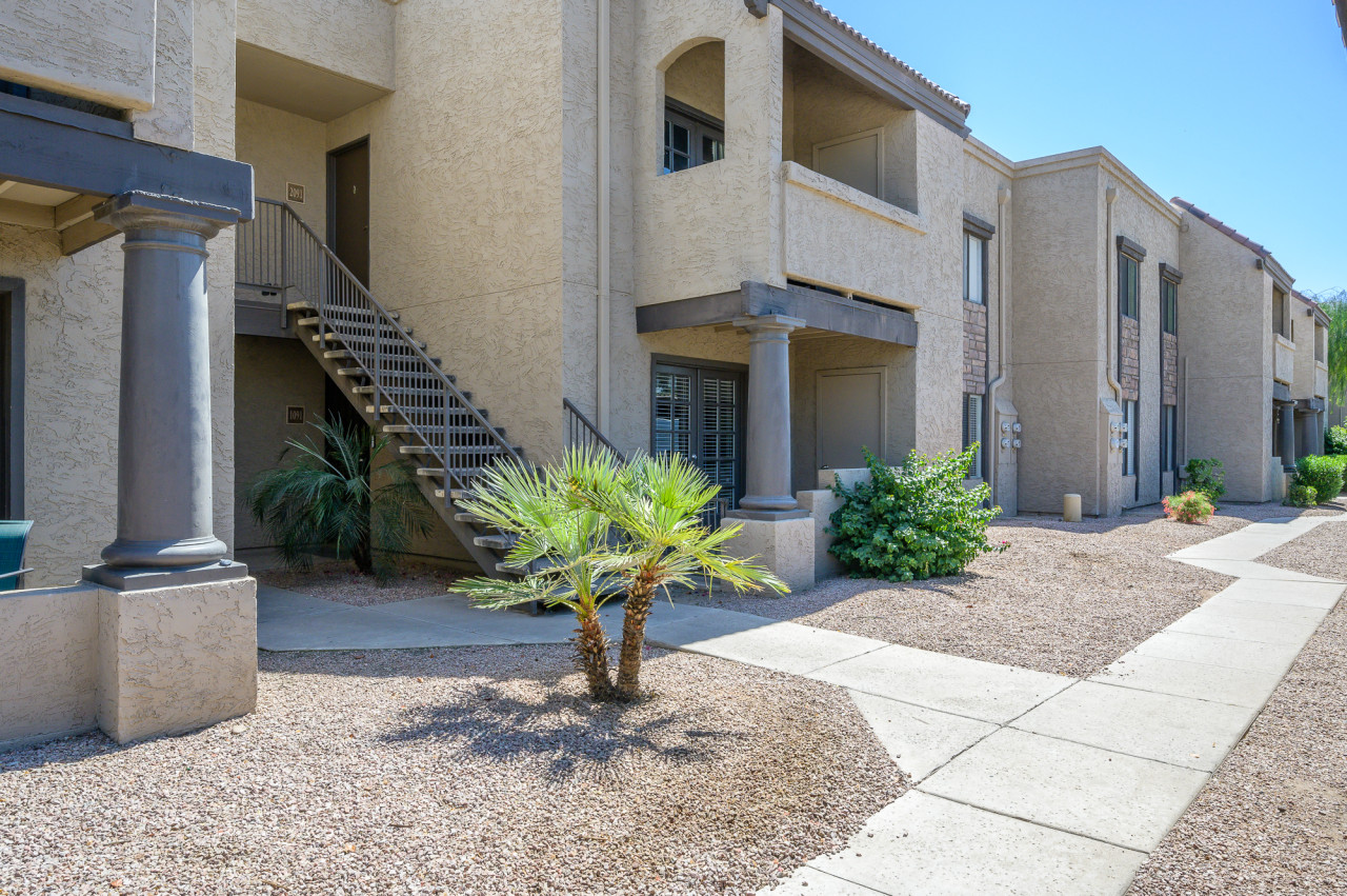Community exterior with landscaped walkways and desert-style grounds.