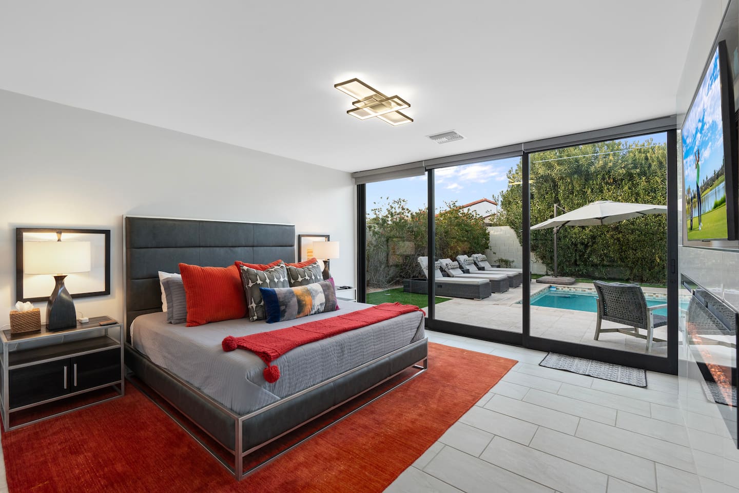 This spacious bedroom opens directly to the pool and lounge area—perfect for a refreshing dip or relaxing sunbathe just steps from bed.