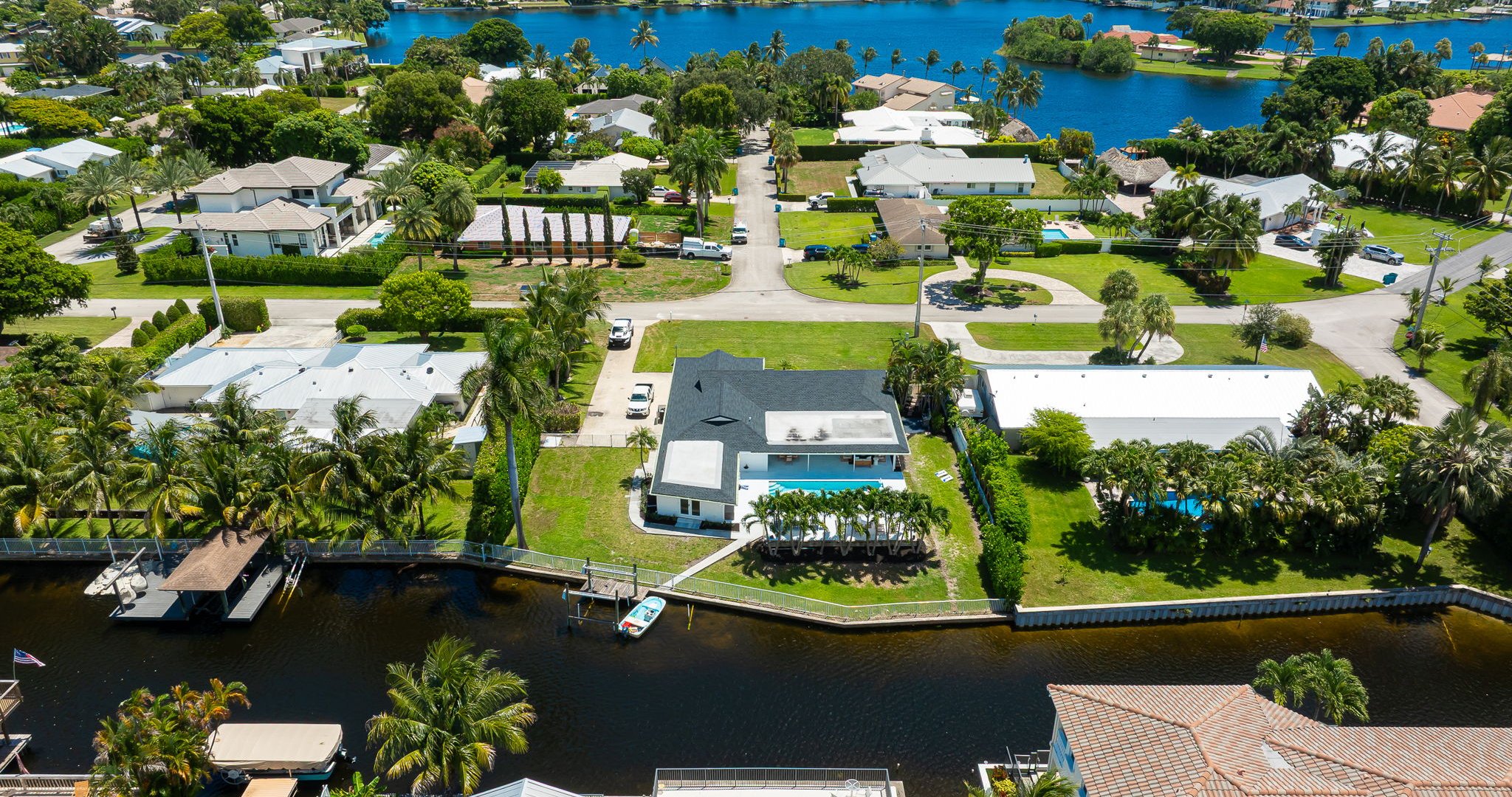 This stunning home sits along a private canal with direct access to Lake Ida, offering a true waterfront retreat. From above, you can see the sparkling pool, lush landscaping, and serene neighborhood that make this property ideal for families and groups.
