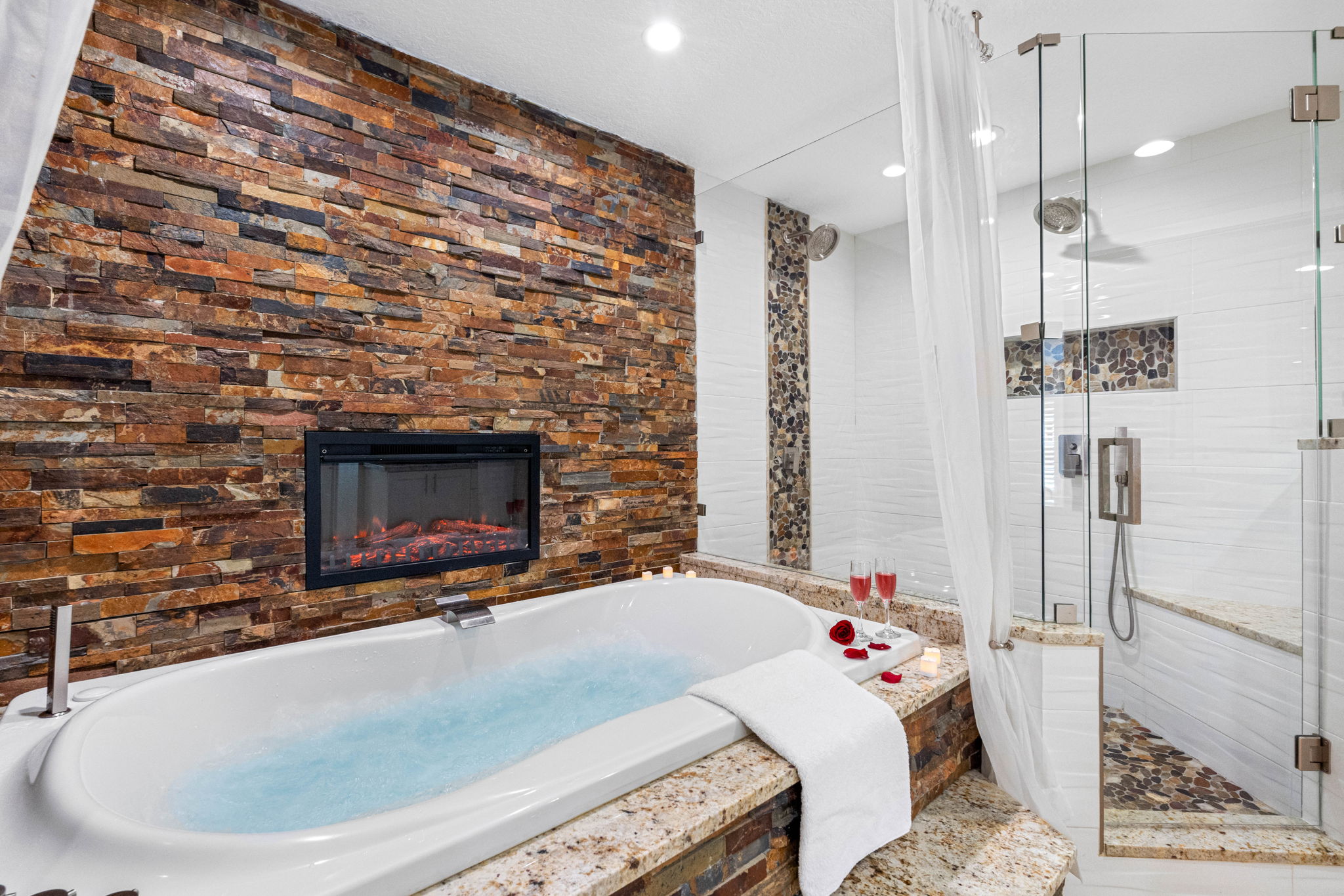 Features a deep soaking tub perfectly positioned in front of a built-in TV.
