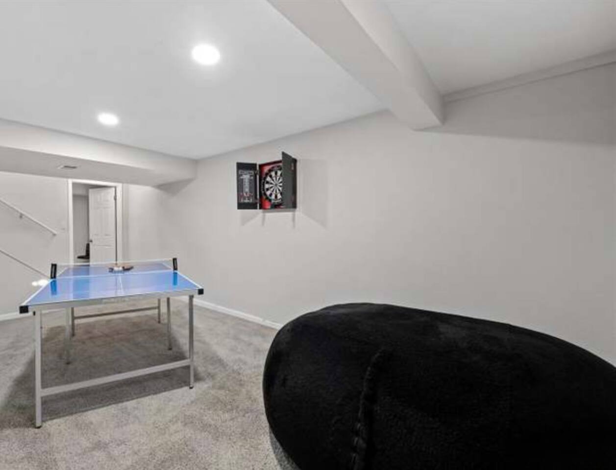 Ping pong and dart board in the basement 