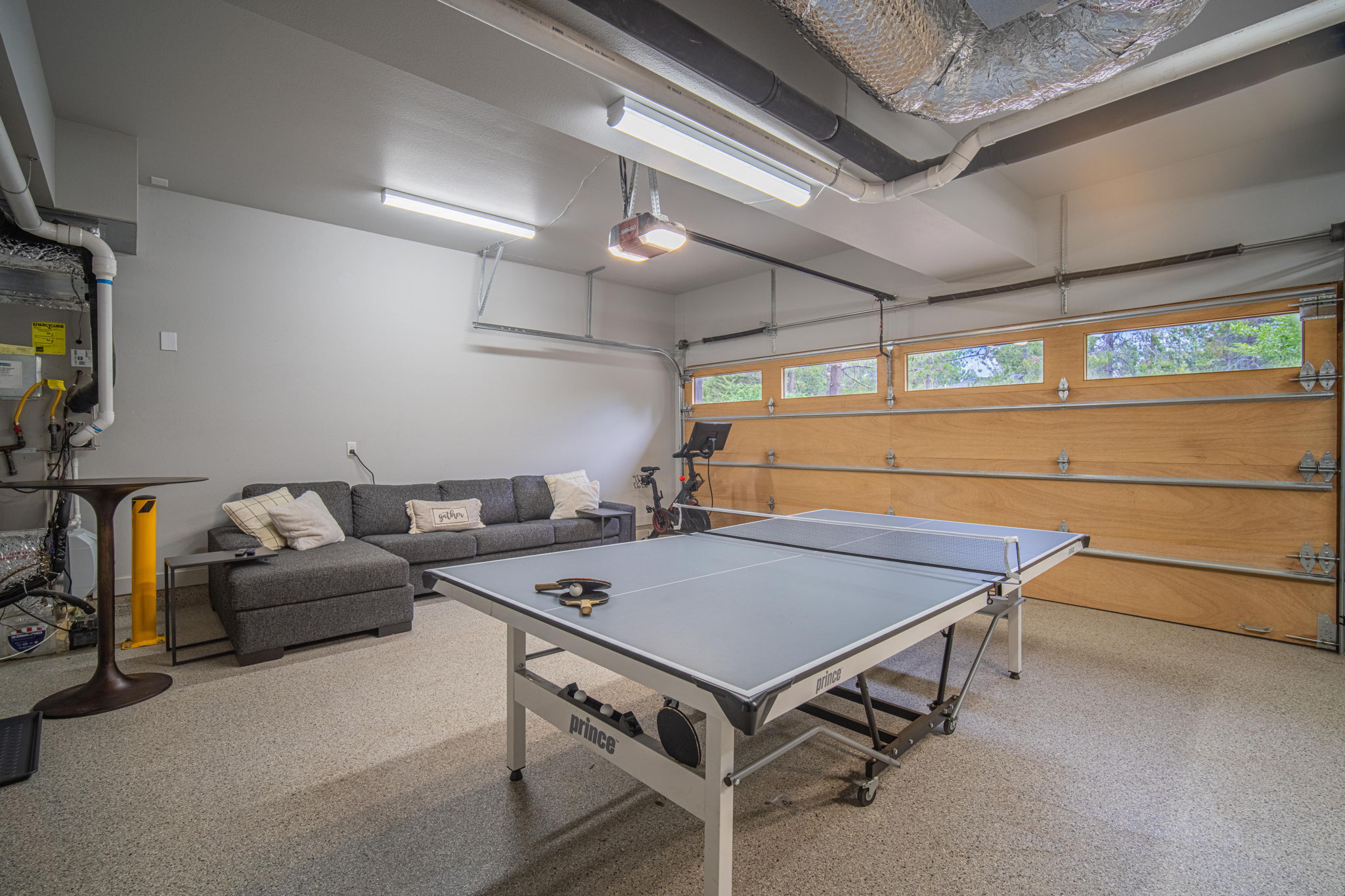 Garage fun! Ping pong table, couch, peloton