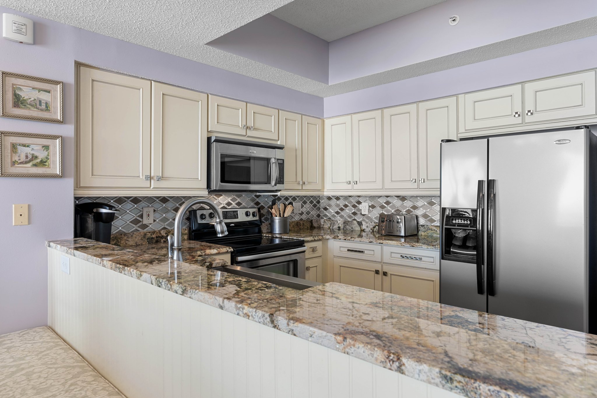 Modern kitchen layout w/ stainless appliances & clean, bright finishes.