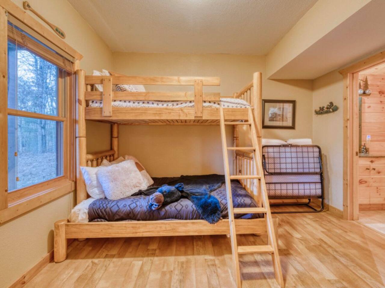 The lower level features a charming bunk room, perfect for cozy nights and shared adventures.