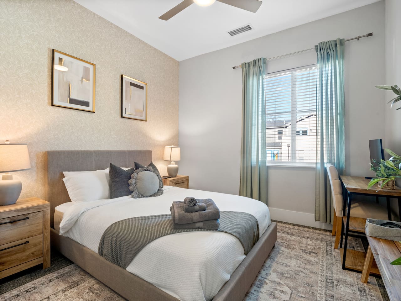 Modern Bedroom with queen mattress and high ceilings, a ceiling fan, easy charging of your phones and portable devices. You will feel at home with this cozy setup! 