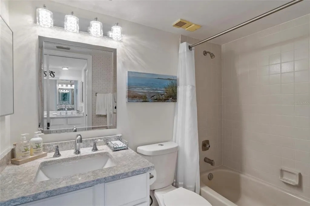 The en-suite master bathroom features a spacious, clean layout with modern finishes, fresh towels, and thoughtful details designed for comfort and convenience.