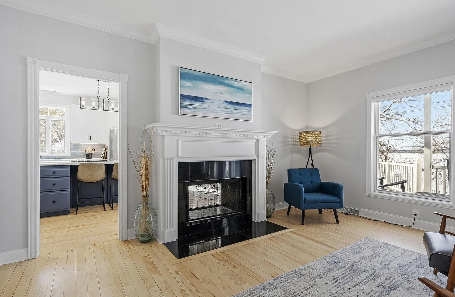 A showstopping live-edge table, from The Furniture House, anchors this spacious lakeview gathering area, offering seating for 14 to enjoy meals, drinks, games, and sunset conversations together.