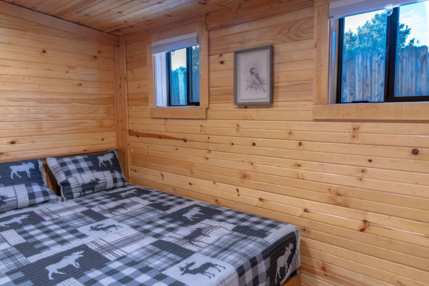 Drift off to sleep with nature’s lullaby and wake up to the cheerful songs of birds in this cozy queen bed. With two small windows framing peaceful outdoor views, it’s the perfect spot to relax, recharge, and embrace the beauty of cabin life!