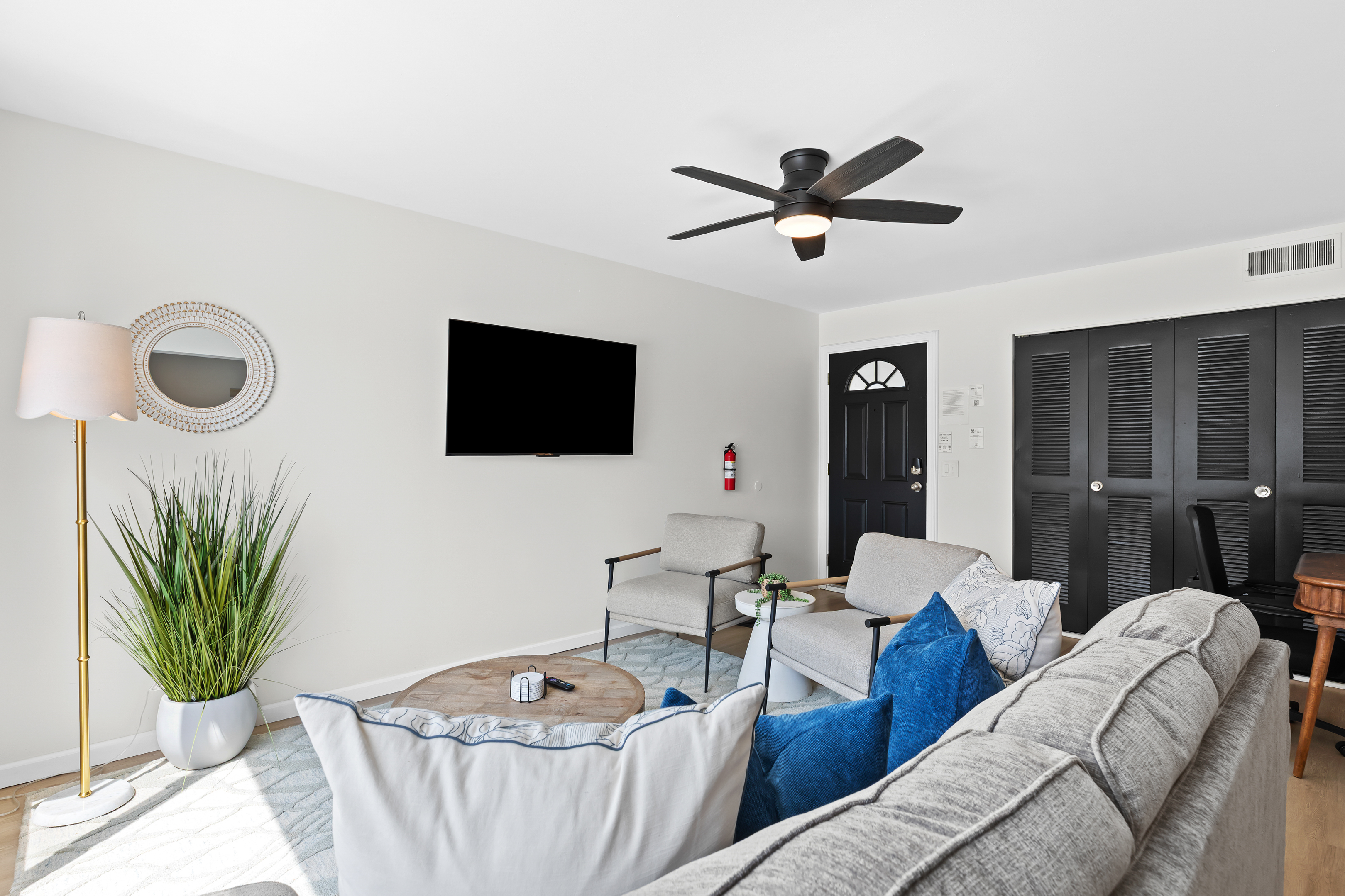 Relax in a stylish living area with plush seating, smart TV, and plenty of natural light.