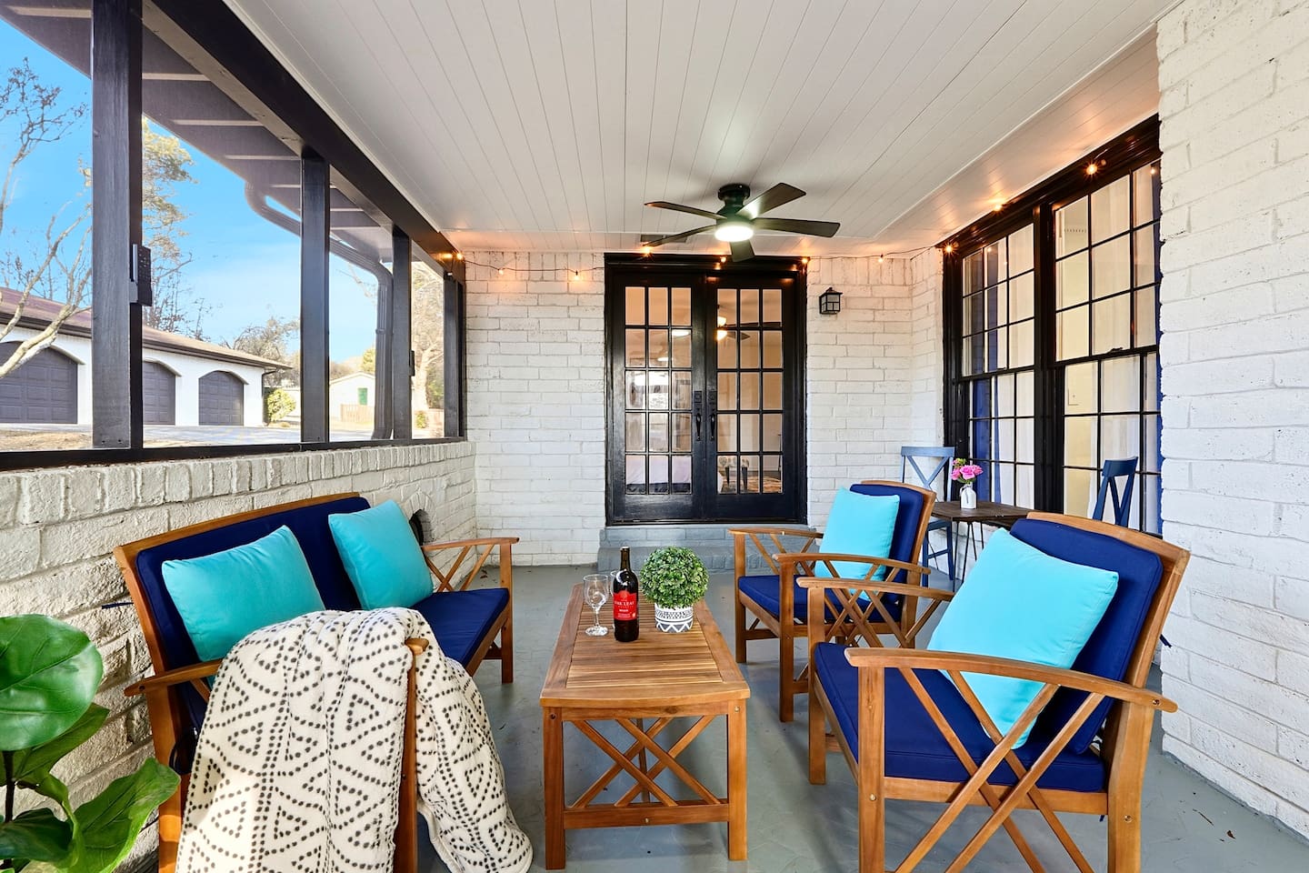 Inviting and spacious sunroom featuring ample seating, perfect for relaxing, unwinding, or spending quality time together.