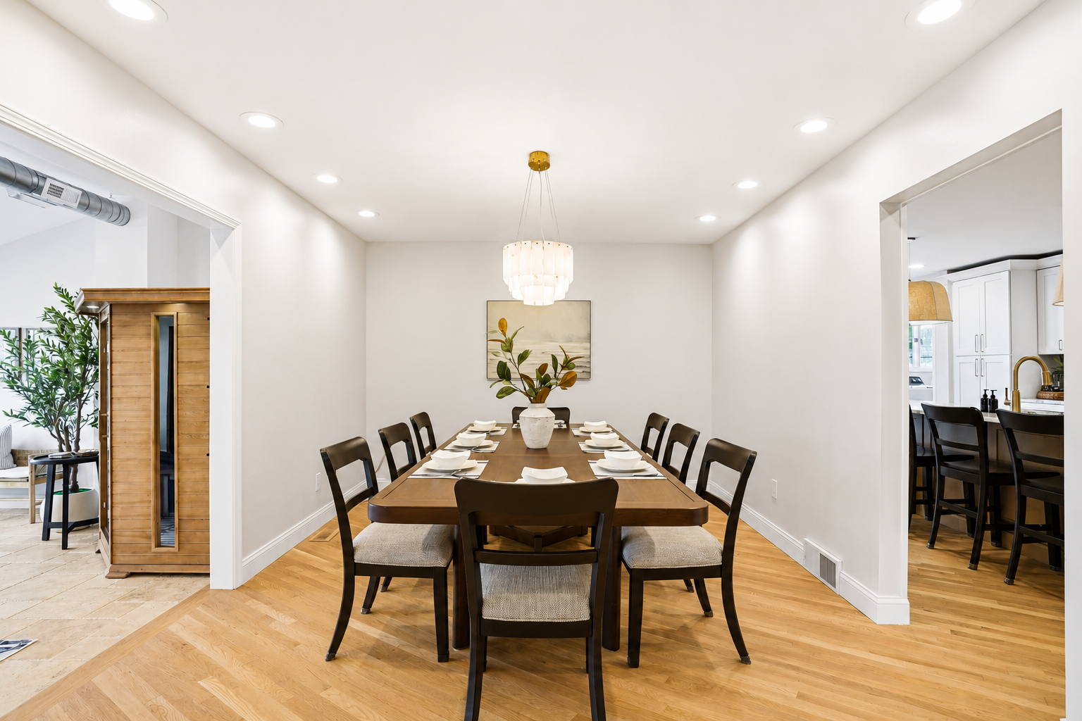 Elegant dining room with a large table, modern seating, and clean minimalist design. Bright, open space ideal for family meals, gatherings, and entertaining in a stylish, upscale setting.
