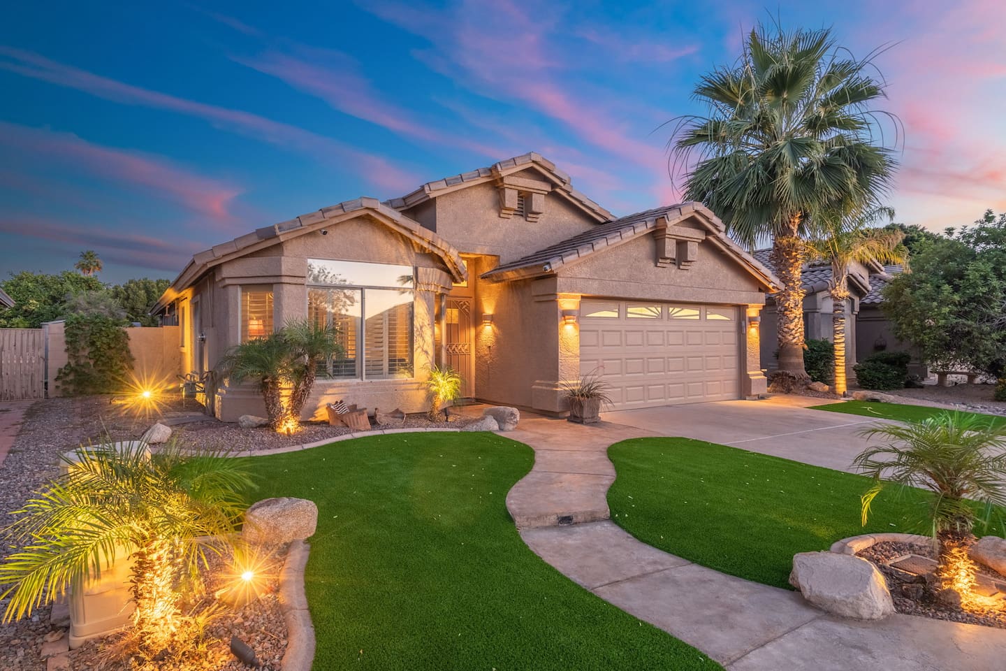  Arrive to a warm desert sunset and a home that looks as good on the outside as it feels on the inside — manicured landscaping, landscape lighting, and a grand palm welcome your home.