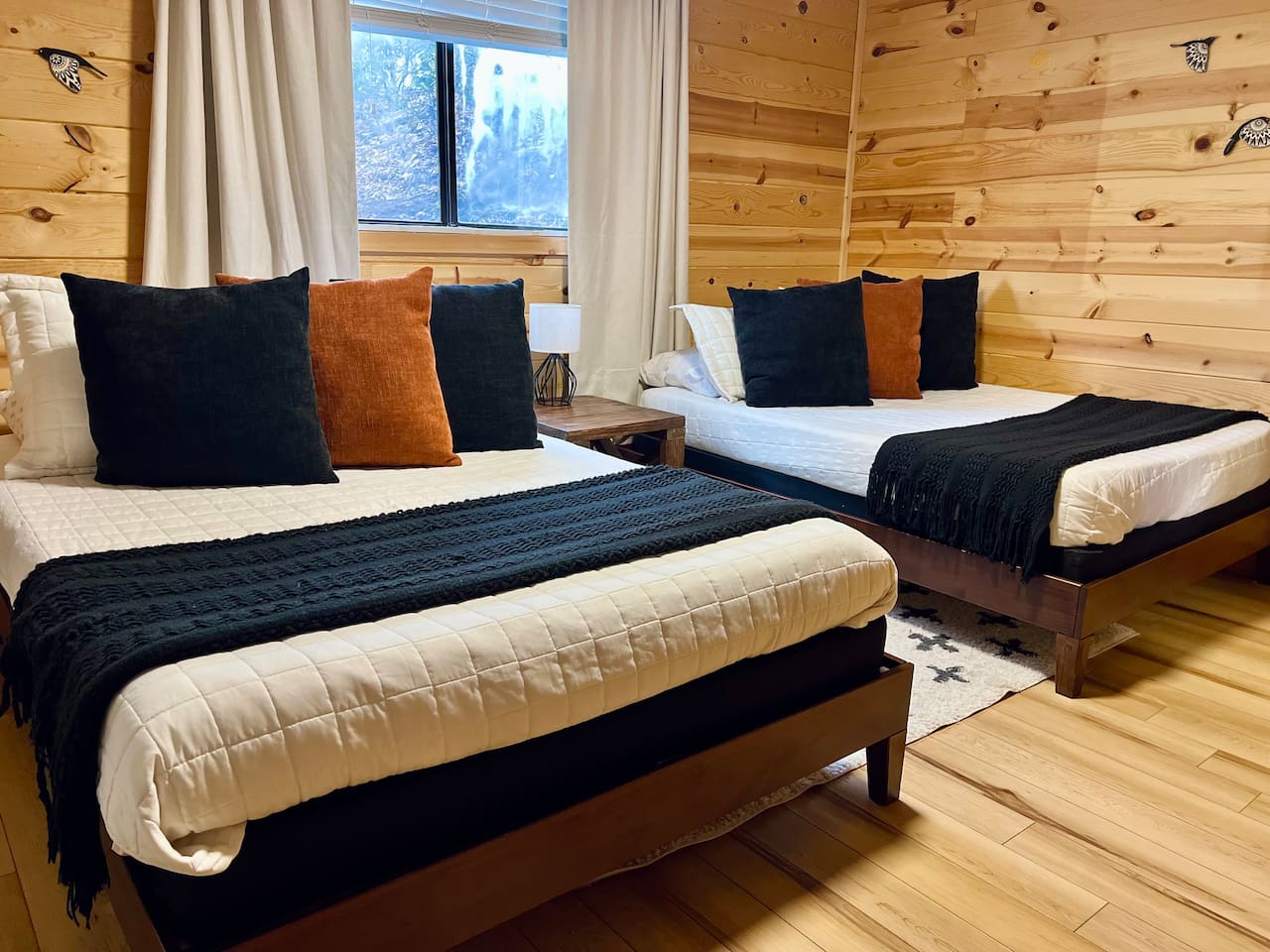 Three of 5 bedrooms pictured, featuring two full-sized beds (sleeps up to 4 people) and a Roku streaming TV.
