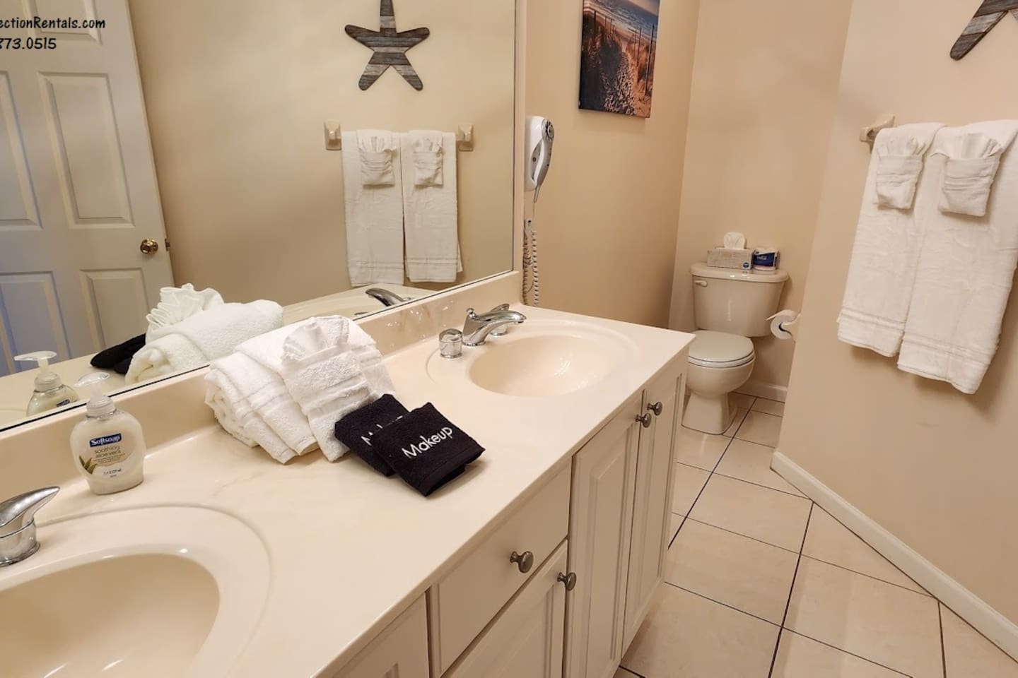 Clean and spacious bathroom with large vanity, tile flooring, and plenty of counter space.